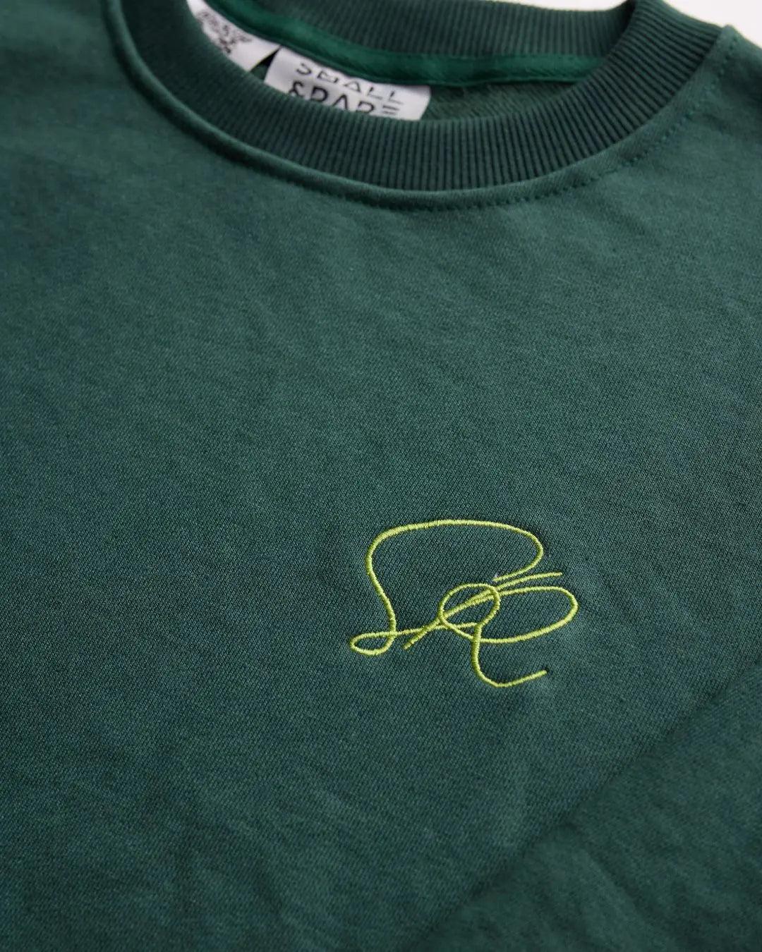 Green core streetwear shirt with a small embroidered logo on the chest.